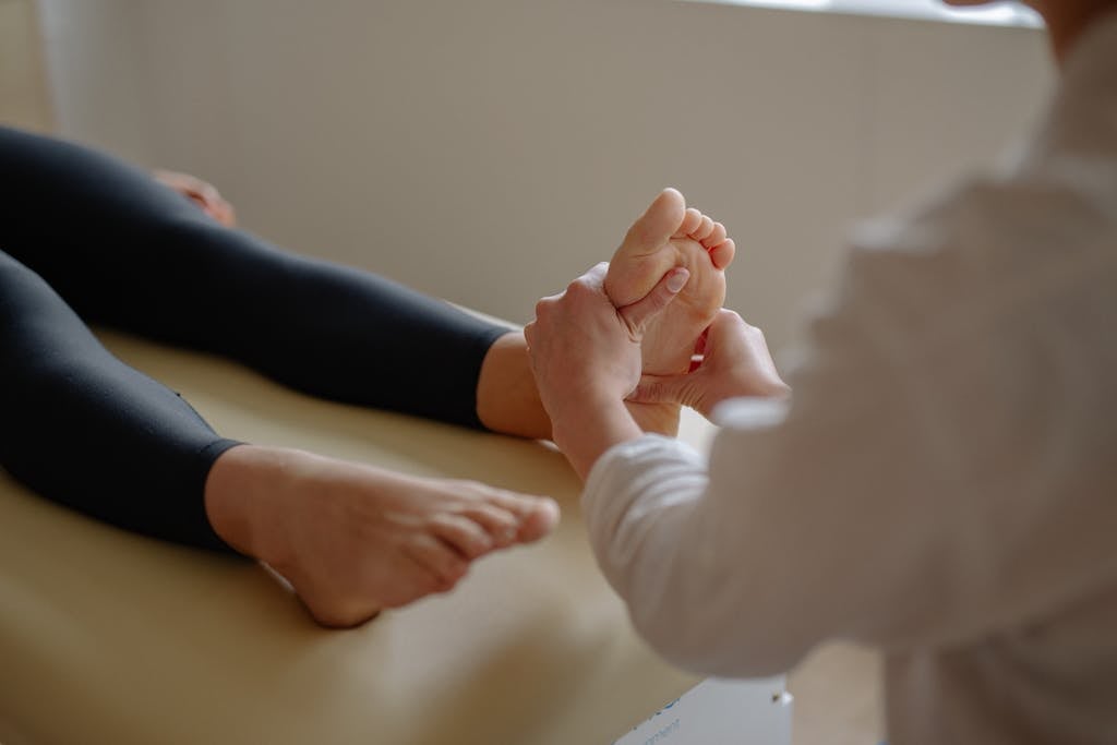 A Person Massaging a Person's Foot