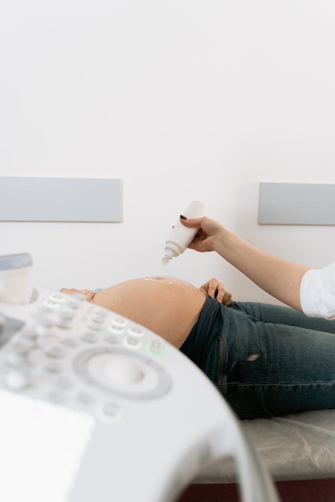 Photo Of Person Applying Gel On Pregnant Woman's Belly